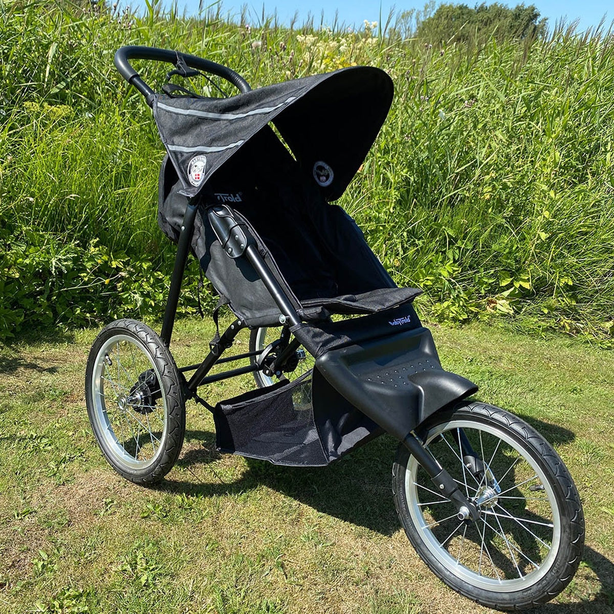 Baby trold Jogger schwarz im Profil auf der Wiese geschlossenen babytrold-jogger-schwarz-profil-wiese-sonnenschutz-geschlossen