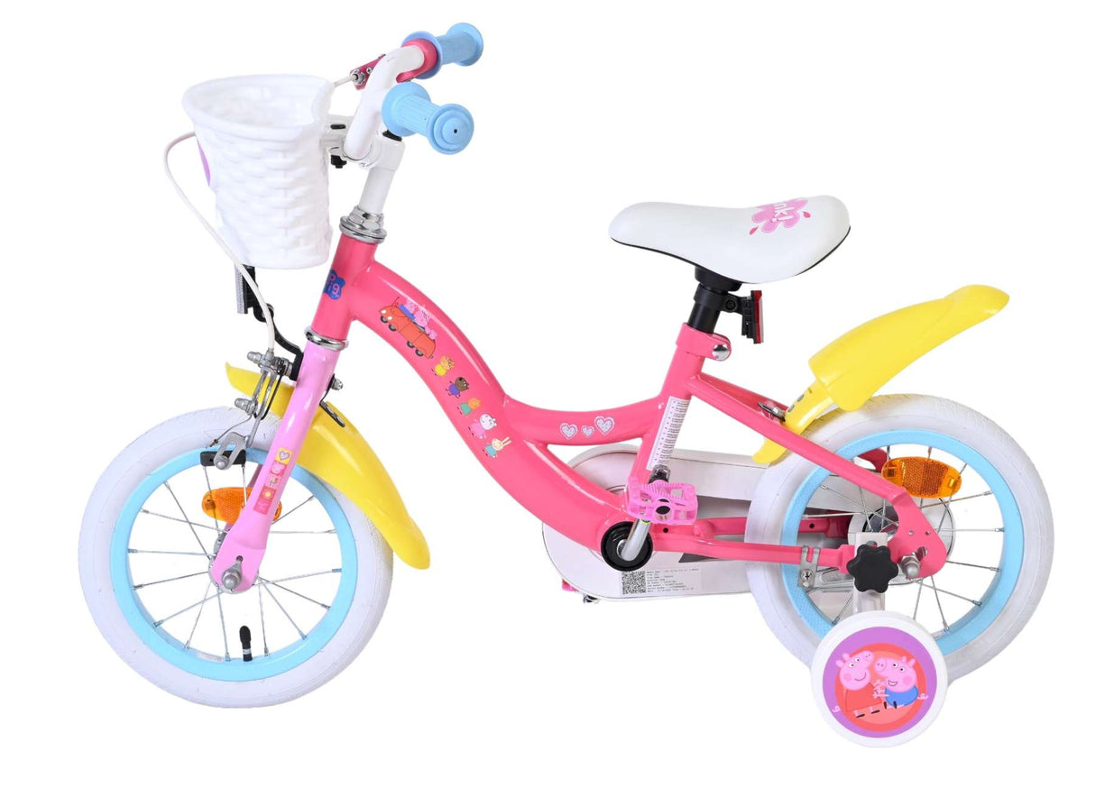 Rosa Kinderfahrrad mit Korb, weißen Reifen und bunten Aufklebern