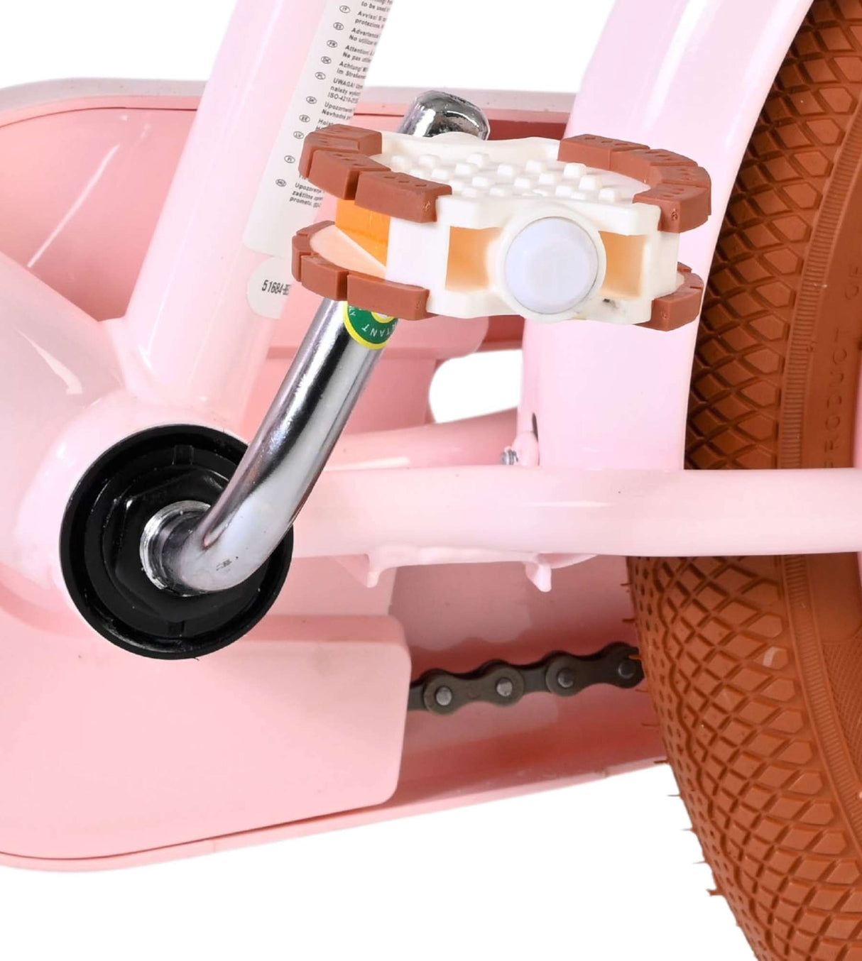 Rosa Kinderfahrrad mit braunen Pedalen und Kettenantrieb