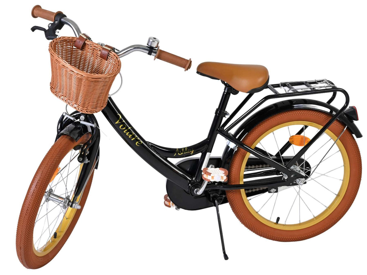Schwarzes Fahrrad mit braunen Reifen und Korb vorne