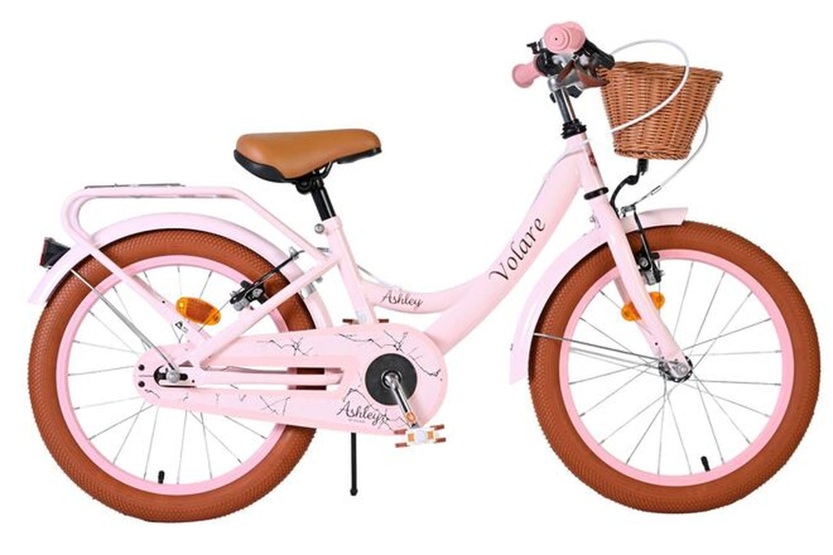 Rosa Kinderfahrrad mit Korb und braunen Reifen