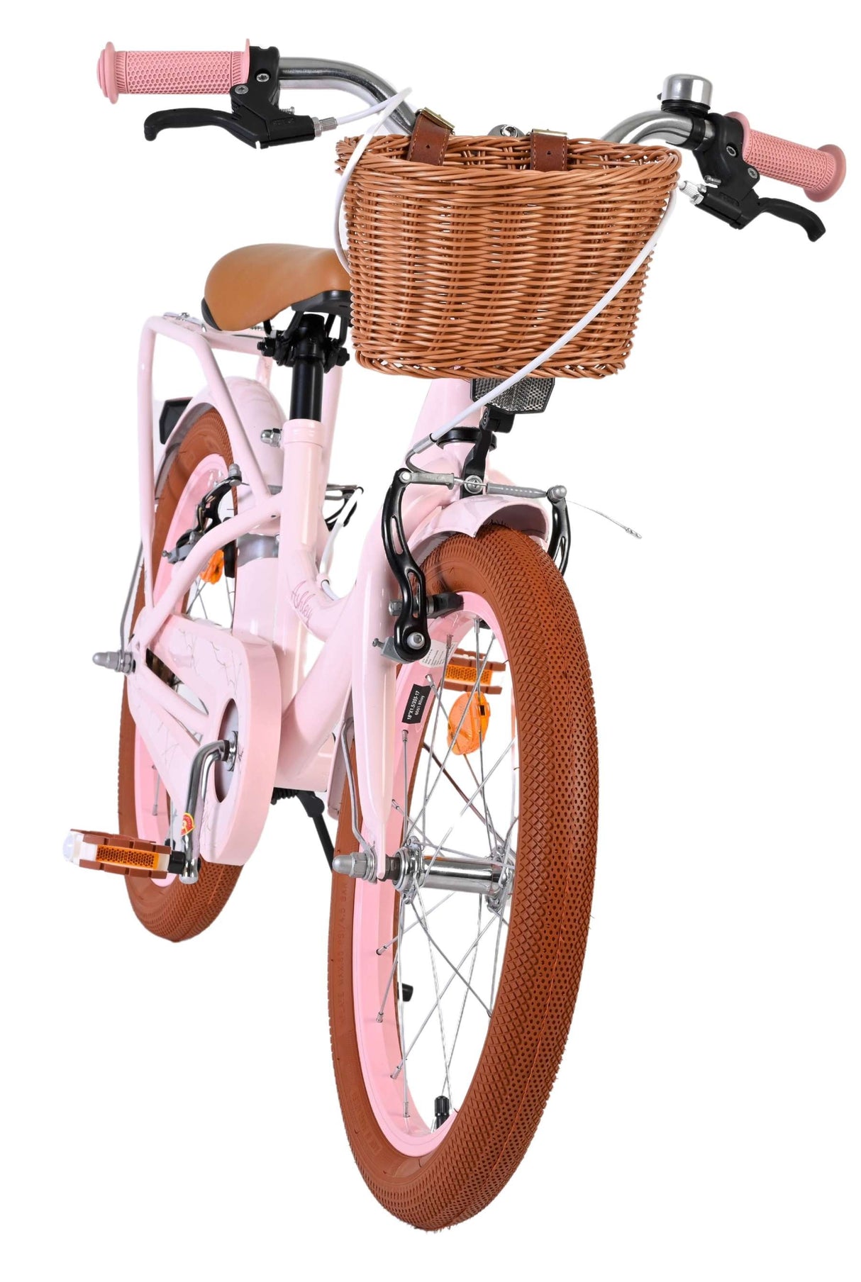 Rosa Kinderfahrrad mit Korb und braunen Reifen