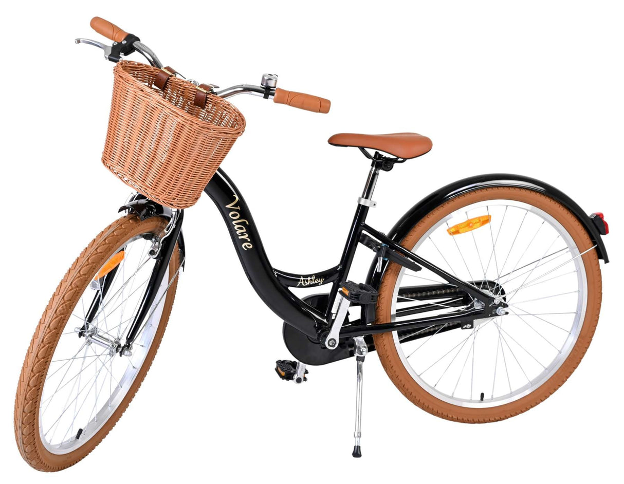 Schwarzes Fahrrad mit Korb, braunen Details und breiten Reifen