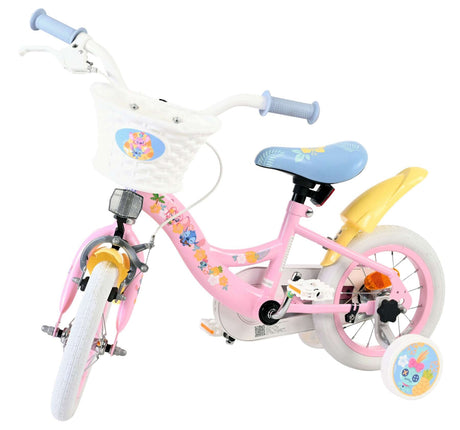Rosa Kinderfahrrad mit Korb, Stützrädern und bunten Blumenmotiven