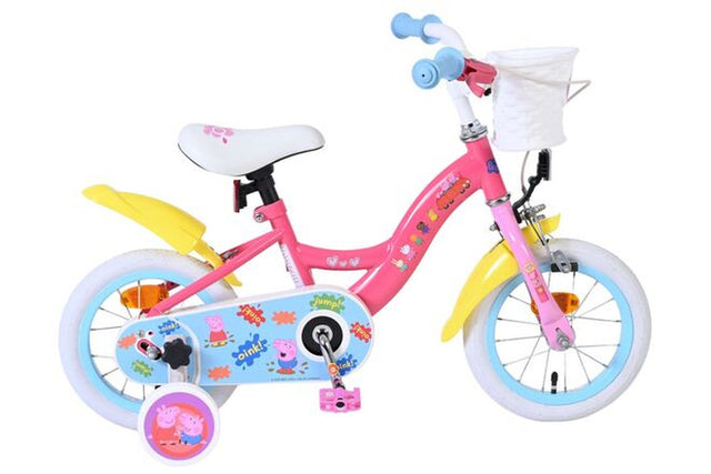 Rosa Kinderfahrrad mit bunten Aufklebern und Korb vorne