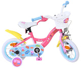 Rosa Kinderfahrrad mit Korb, bunten Aufklebern und stabilen Reifen