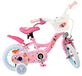 Rosa Kinderfahrrad mit bunten Aufklebern und Korb vorne