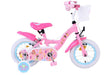 Rosa Kinderfahrrad mit Korb, Aufklebern und Stützrädern