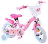 Rosa Kinderfahrrad mit Korb, bunten Aufklebern und weißen Reifen