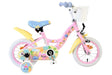 Kinderfahrrad in Pink mit bunten Aufklebern und Korb vorne