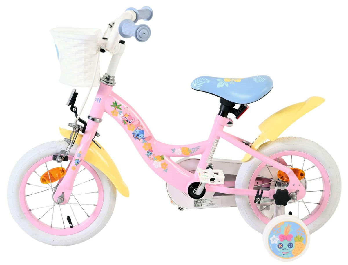 Rosa Kinderfahrrad mit Blumenmotiven und Korb vorne