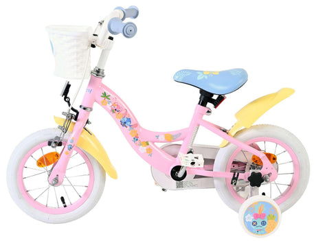 Rosa Kinderfahrrad mit Blumenmotiven und Korb vorne