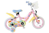 Kinderfahrrad in Pink mit bunten Aufklebern und Korb vorne