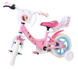 Rosa Kinderfahrrad mit Korb, Stützrädern und bunten Aufklebern