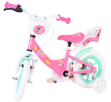 Kinderfahrrad in Pink mit weißen Reifen und Korb vorne