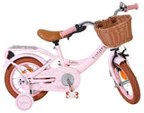 Rosa Kinderfahrrad mit Korb und braunen Reifen