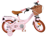 Rosa Kinderfahrrad mit Korb und braunen Details, stabiler Rahmen