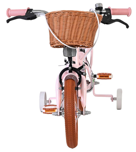 Rosa Kinderfahrrad mit Korb und Stützrädern vorneansicht