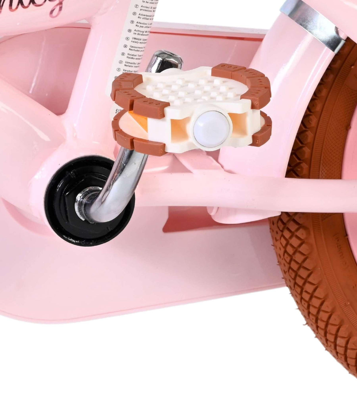 Rosa Kinderfahrrad mit braunen Pedalen und Gummireifen
