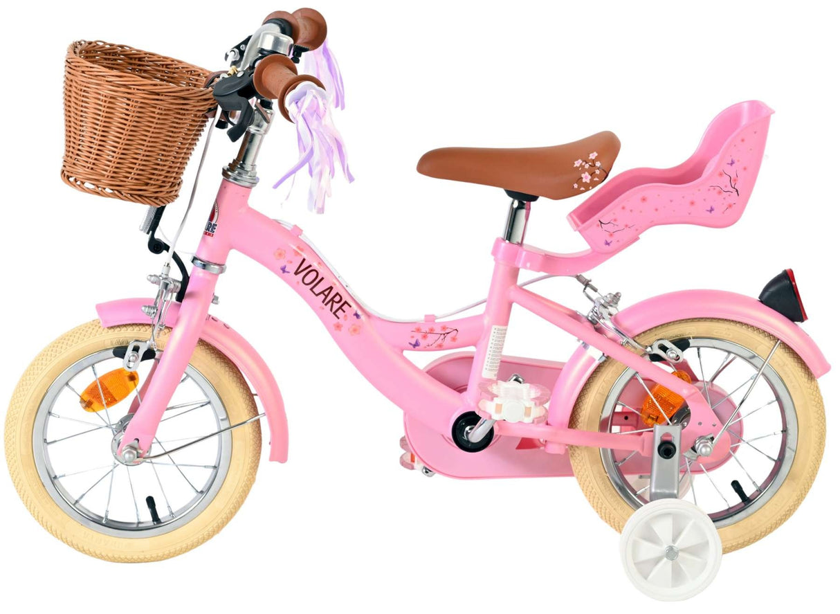 Rosa Kinderfahrrad mit Korb, Sattel und Stützrädern