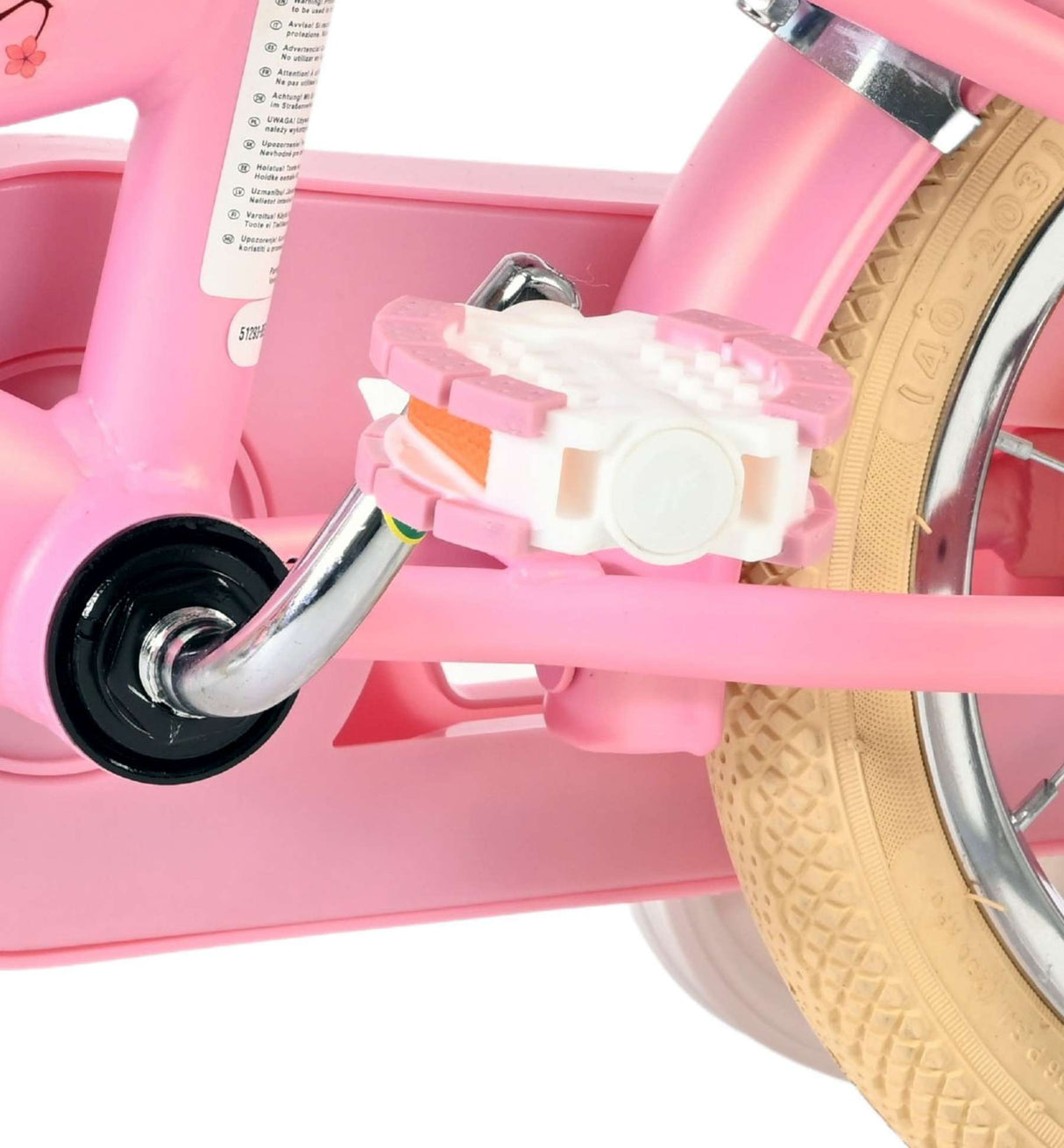 Rosa Fahrradpedal mit weißem Reflektor und beigem Reifen
