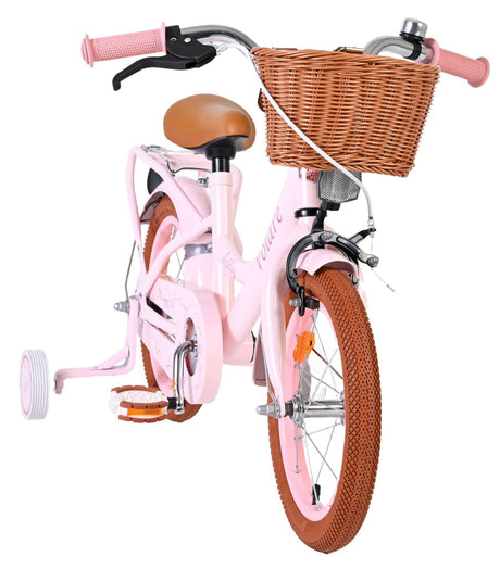 Rosa Kinderfahrrad mit Korb, Stützrädern und braunen Reifen