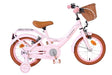 Rosa Kinderfahrrad mit Korb, braunem Sattel und Stützrädern