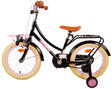 Schwarzes Kinderfahrrad mit pinken Akzenten und stabilen Stützrädern