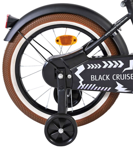 Schwarzes Fahrrad mit braunem Reifen und reflektierendem Rücklicht