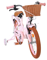 Rosa Kinderfahrrad mit Korb und braunen Reifen