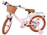 Rosa Kinderfahrrad mit Korb und braunen Reifen