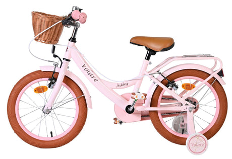 Rosa Kinderfahrrad mit Korb, braunem Sattel und dicken Reifen
