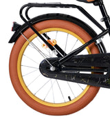 Schwarzes Fahrrad mit braunem Reifen und goldfarbener Felge