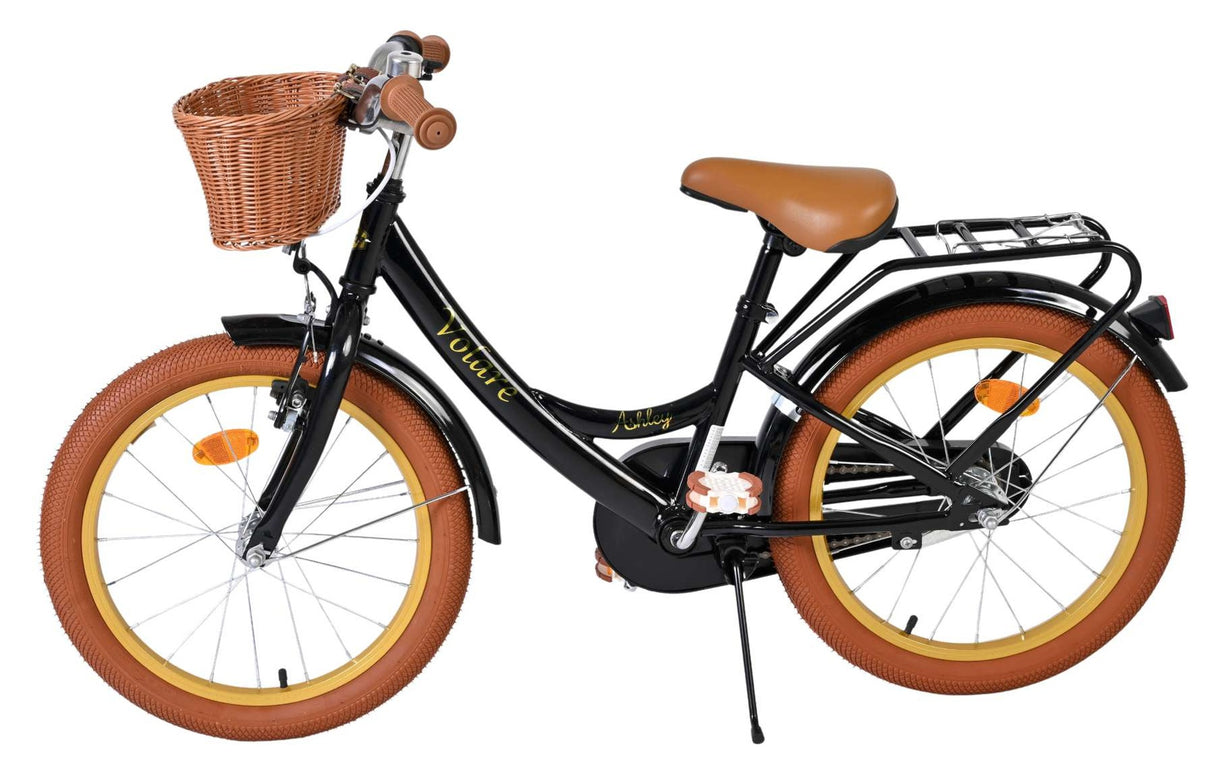 Schwarzes Kinderfahrrad mit Korb und braunen Reifen