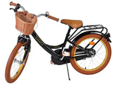 Schwarzes Fahrrad mit braunen Reifen und Korb vorne