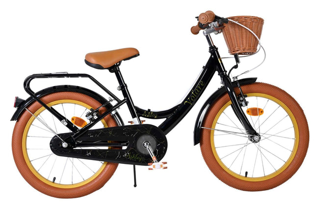 Schwarzes Kinderfahrrad mit braunem Korb und dicken Reifen