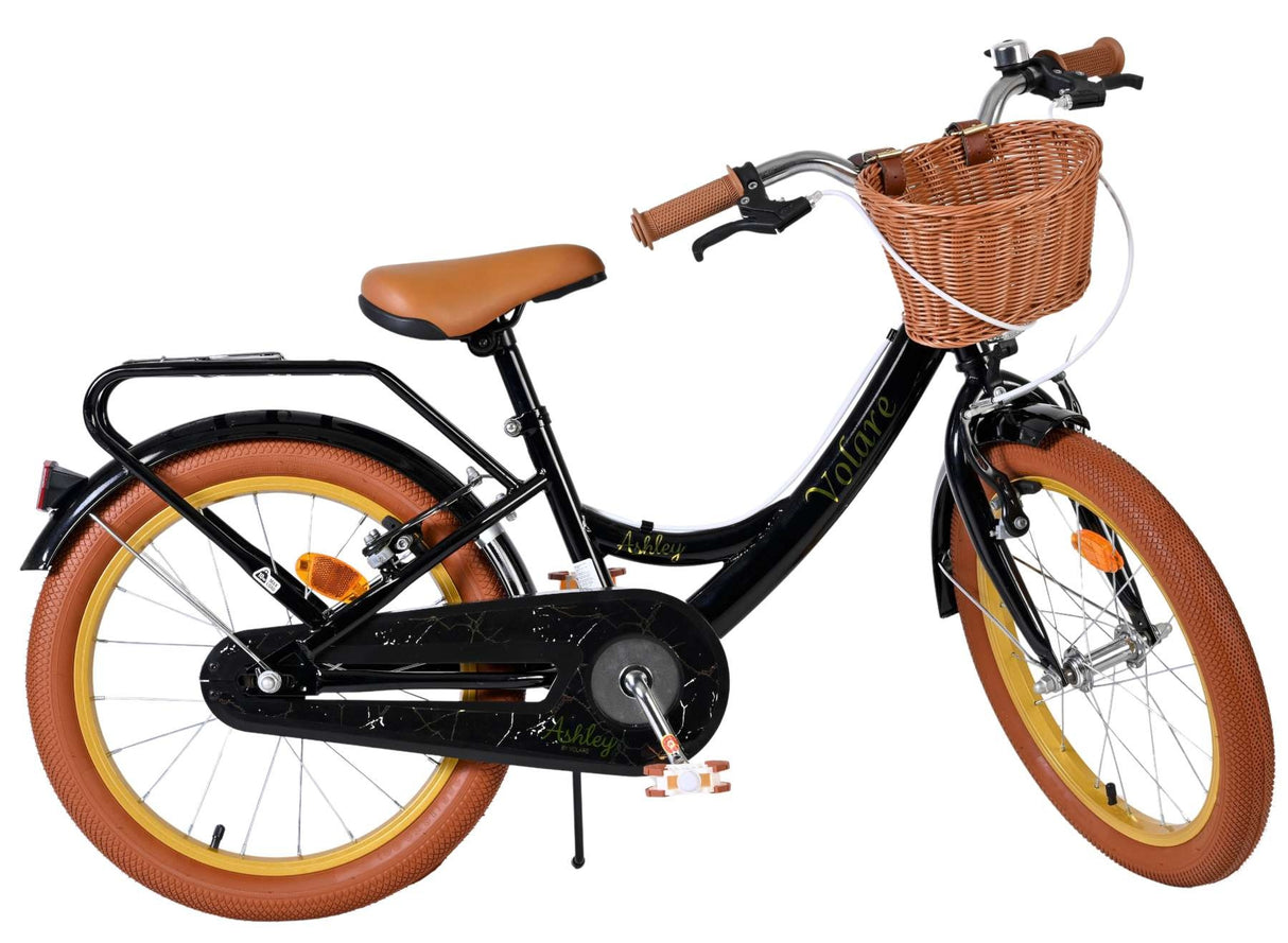 Schwarzes Kinderfahrrad mit Korb, braunen Reifen und gepolsterter Sitzfläche