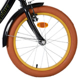 Schwarzes Fahrrad mit braunem Reifen und gelbem Felgenrand