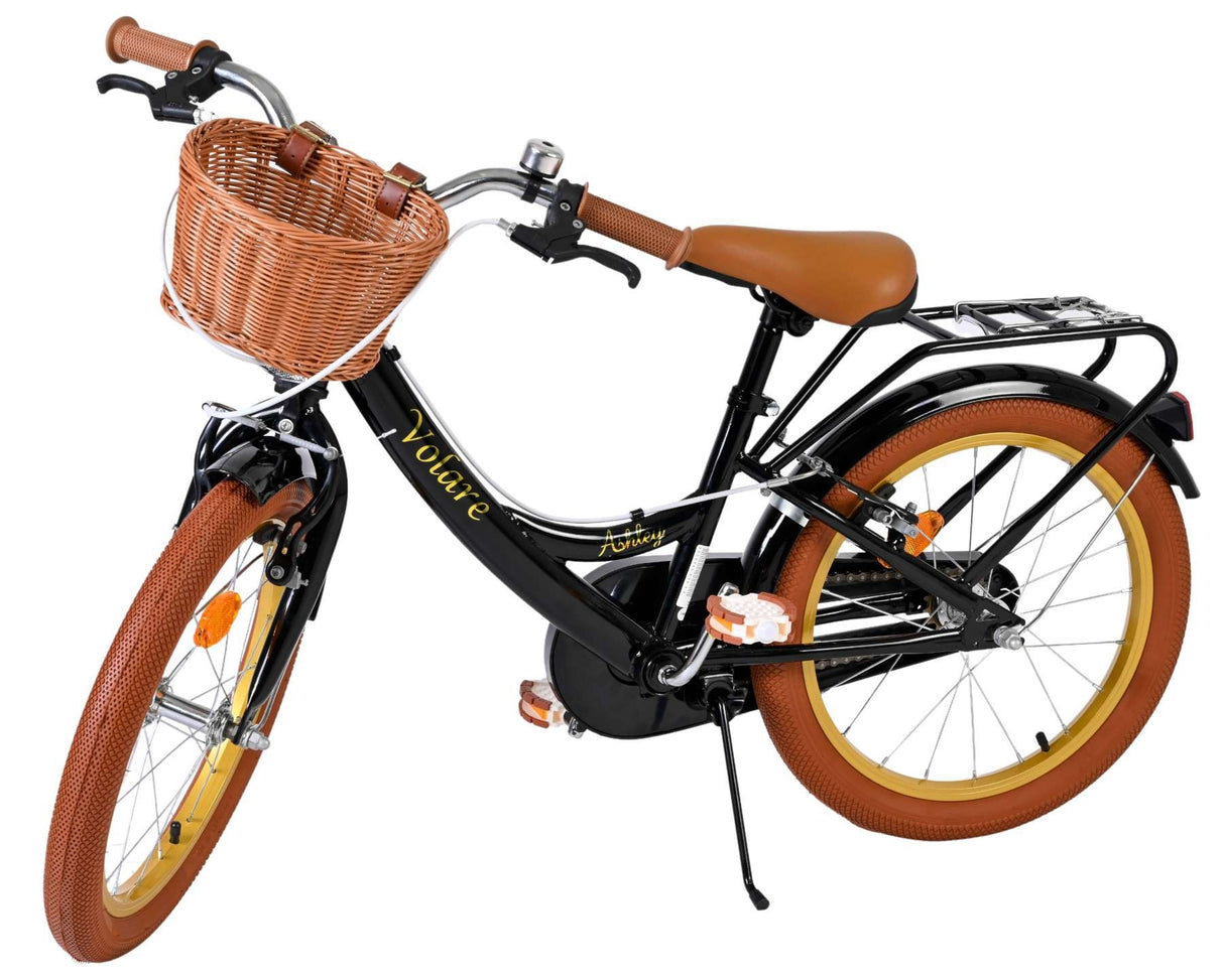 Schwarzes Fahrrad mit Korb, braunen Griffen und Reifen in zwei Farben