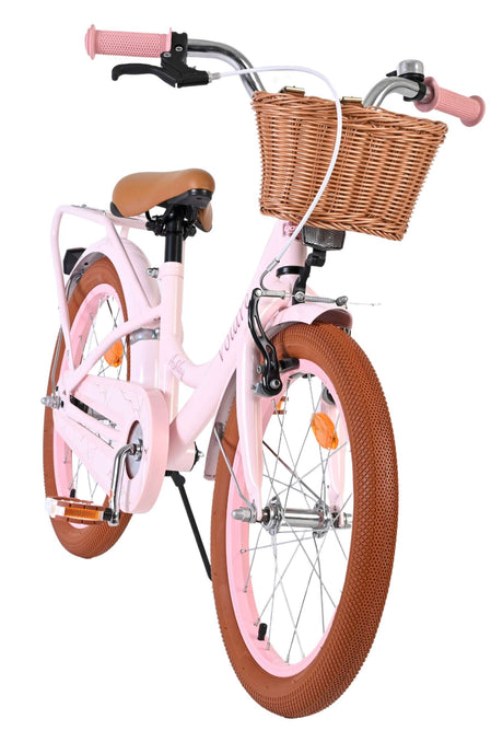 Rosa Kinderfahrrad mit Korb und braunen Reifen