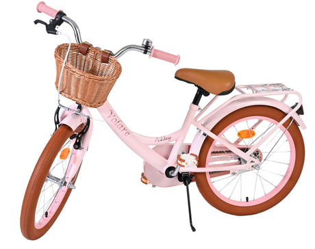 Rosa Kinderfahrrad mit Korb, braunen Griffen und Reifen