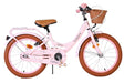 Rosa Kinderfahrrad mit Korb und braunen Reifen