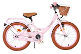 Rosa Kinderfahrrad mit Korb und braunen Reifen