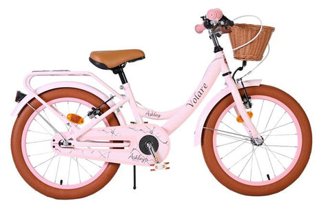 Rosa Kinderfahrrad mit Korb und braunen Reifen