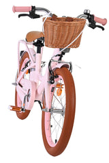 Rosa Kinderfahrrad mit Korb und braunen Reifen