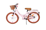 Rosa Kinderfahrrad mit Korb und braunen Reifen