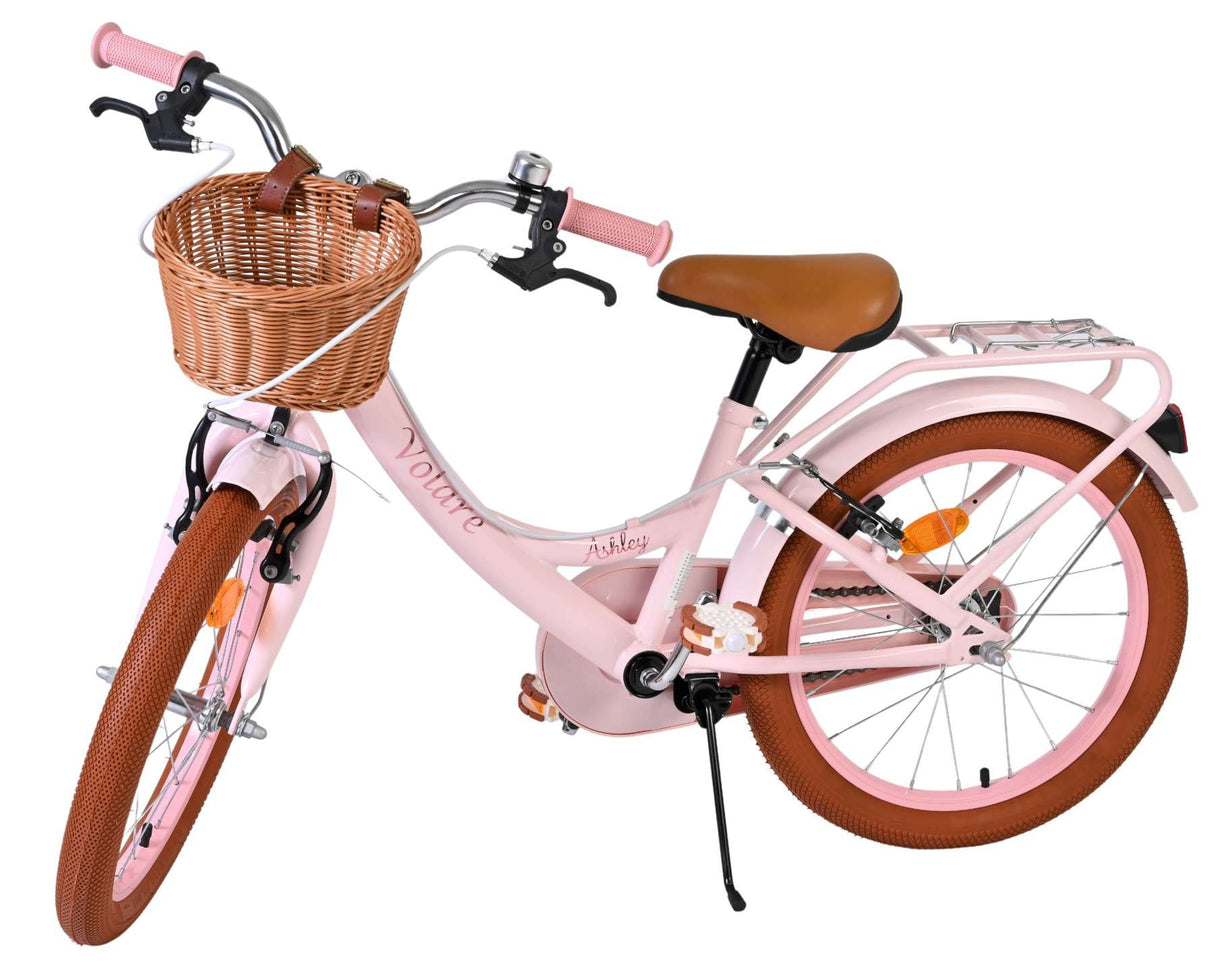 Rosa Damenfahrrad mit Korb und braunen Reifen