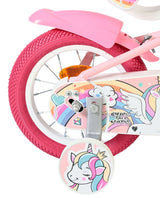 Rosa Kinderfahrrad mit Einhorn-Motiv und bunten Reifen
