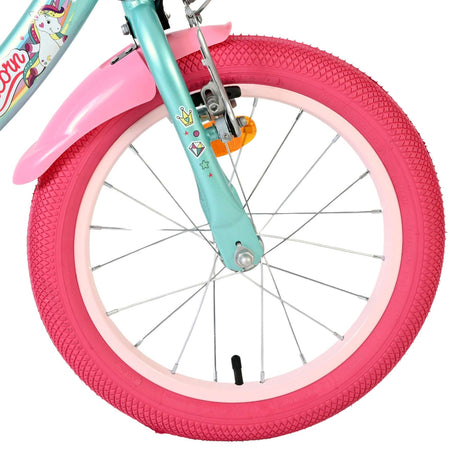 Bunte Fahrradfelge mit pinkem Reifen und dekorativen Aufklebern