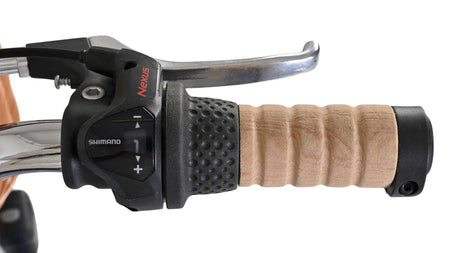 Griff eines Fahrrads mit Schaltknopf und Holzoptik
